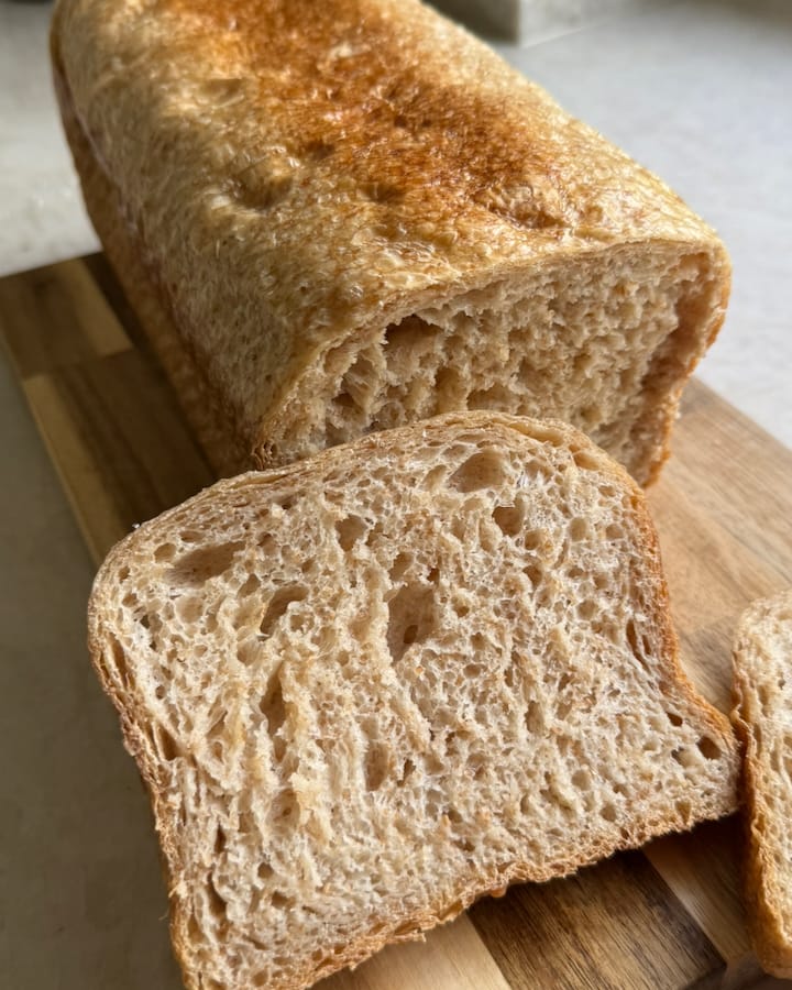A sourdough pan loaf with the first slice cut