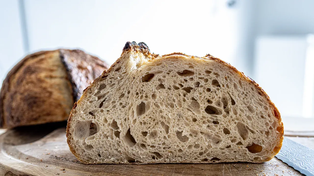 Freshly baked sourdough loaf with an open crumb